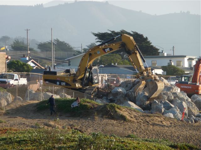 Backhoe on the rock pile